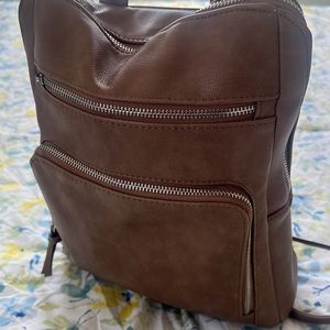 Light brown backpack. 3 compartments . Lightweight backpack . Basically new :)